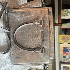 Michael Kors embossed leather handbag with optional crossbody strap.